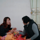 Wang’s mother (R) gives a pack of tea to Zhao Yuqing as a gift before Zhao leaves.